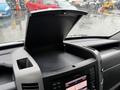 The dashboard of a 2016 Mercedes-Benz Sprinter featuring an open storage compartment and a display screen with controls
