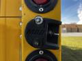 A close-up of a truck's rear light mount featuring the letters MBB with a screw and a small rod attached