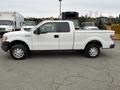 A white 2010 Ford F-150 pickup truck viewed from the side with a standard cab and a pickup bed