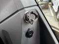 A close-up of the control panel in a 2024 Caterpillar 306 showcasing a round connector and a 12-volt power socket