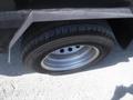 A flat tire on a 2017 Ford Transit with a silver rim and a black tire tread showing wear and tear