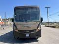 A 2008 Newmar Canyon Star 36 Foot Class A Motorhome with a brown and black exterior parked on a street