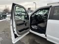 A white 2017 Ford F-150 with an open driver's side door showcasing the interior and dashboard