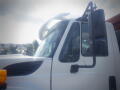 A white 2016 International WorkStar 7500 truck with a large side mirror and a prominent cab design