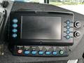 A control panel featuring various buttons and a digital screen on a 2009 Spartan Gladiator vehicle