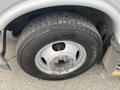 Close-up of a tire and wheel assembly from a 2017 Chevrolet Express showing tread pattern and wheel details