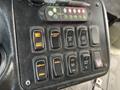 Control panel of a 2012 Chevrolet Express with multiple buttons for door operations interior lights and ramp functions