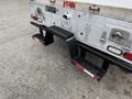 A 2015 Ford F-350 SD with a diamond plate truck bed and step attachments on the rear for easier access to the cargo area