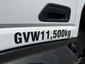 A close-up of a 2009 Ford LCF 550 with a visible label showing a gross vehicle weight of 11,500 kg