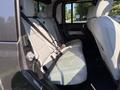 Interior view of the back seat area of a 2021 Jeep Gladiator featuring light gray leather seats with seatbelts and two headrests visible