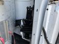 A close-up view of the internal structure of a 2014 Chevrolet Express showing mechanical components including a support bracket and wiring