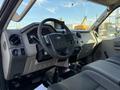 Interior view of a 2009 Ford F-550 showing the dashboard steering wheel and front seats designed for a large utility vehicle