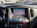 Interior dashboard of a 2017 Infiniti QX50 featuring a navigation screen and multiple control buttons