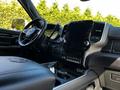 Interior of a 2022 RAM 3500 featuring a large touchscreen display dual cup holders and a steering wheel with the RAM logo