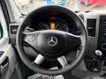 Steering wheel of a 2016 Mercedes-Benz Sprinter featuring the brand logo and control buttons