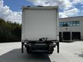 A 2020 Hino 338 truck with a white cargo box is parked facing forward with its rear view visible and a loading area at the back