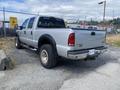 A silver 2007 Ford F-350 Super Duty truck parked with a large cab and bed visible from the rear angle