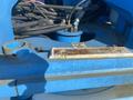 Close-up view of the hydraulic controls and connections on a 1997 Genie S-65 4X4 showing a weathered control plate and various hoses and fittings
