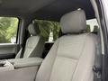 Interior view of a 2020 Ford F-550 with gray fabric seats and a center console between them