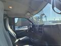 Interior view of a 2013 Chevrolet Express with gray upholstery featuring a steering wheel dashboard and controls on the center console