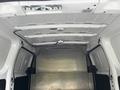 Interior view of a 2020 Nissan NV200 cargo van with a metal floor and white walls showing empty space for storage or transport