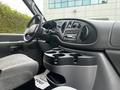 Interior view of a 2008 Ford Econoline showing the dashboard with controls and a console featuring multiple cup holders