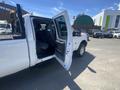 A white 2016 Ford F-350 SD with an open door revealing the interior and seating area