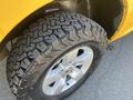 Close-up of the tire and wheel of a 2015 RAM 1500 featuring rugged tread design and a silver alloy rim