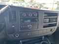 Dashboard of a 2013 Chevrolet Express featuring air conditioning controls a radio and multiple vents