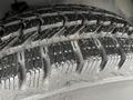 Close-up of a tread pattern on a tire of a 2014 Chevrolet Express showing detailed grooves and rubber texture