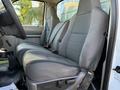 Interior view of a 2009 Ford F-550 showing two gray front seats with seatbelts and manual adjustments