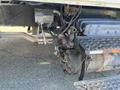 The image shows the undercarriage of a 2007 International 7300 featuring exposed wiring and plumbing connected to the vehicle's engine and transmission components