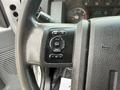 Close-up of the steering wheel of a 2017 Ford F-750 featuring control buttons for information settings and system adjustments