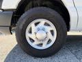 Close-up of a silver alloy wheel with a Goodyear Wrangler tire mounted on a 2011 Ford Econoline