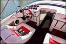 Interior view of a 1989 Nordic Viking boat featuring a steering wheel with a red and white color scheme along with a dashboard equipped with multiple gauges and controls