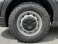 Close-up of a wheel from a 2022 Ford Transit featuring a rugged tire tread and a gray metal rim
