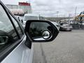 A 2025 Toyota Corolla side mirror reflecting a circular view of the surroundings