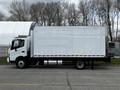 A 2018 Hino 195 box truck with a white cargo area and a black chassis parked on the street