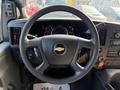 Steering wheel of a 2020 Chevrolet Express displaying the Chevrolet logo with dashboard gauges and controls visible in the background