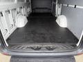 A 2019 Mercedes-Benz Sprinter with a spacious and empty cargo area featuring a flat black floor and side walls designed for transport and storage