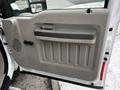 The image shows the interior door panel of a 2008 Ford F-450 SD featuring light brown plastic with a large door handle and textured sections for grip