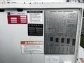 A 2008 International 7500 truck with various safety and operational warning labels and load rating charts displayed prominently on the side