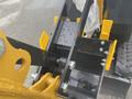 Close-up of a 2024 AGT Industrial H13R Mini Excavator's attachment area showcasing metal components and a blade with water droplets