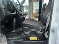 Interior view of the driver's seat of a 2017 Chevrolet Express showing a black upholstered seat and dashboard controls