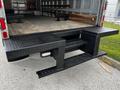 A 2018 Hino 195 with a black textured loading ramp and steps attached to the rear for easy access to the truck bed