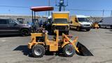 A 2024 Traner TR45 compact tractor with a front loader and a red canopy on an industrial lot