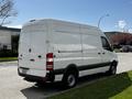 A white 2012 Mercedes-Benz Sprinter van parked on the street with a high roof design and no side windows