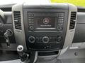 Dashboard of a 2017 Mercedes-Benz Sprinter featuring a multimedia display and control knobs along with a gear shift and ignition key