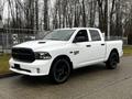 A white 2022 RAM 1500 Classic pickup truck with black wheels and a front grille featuring the RAM logo