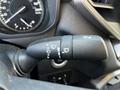 A close-up of a 2023 Toyota Tundra's turn signal and wiper control stick with various symbols indicating different functions